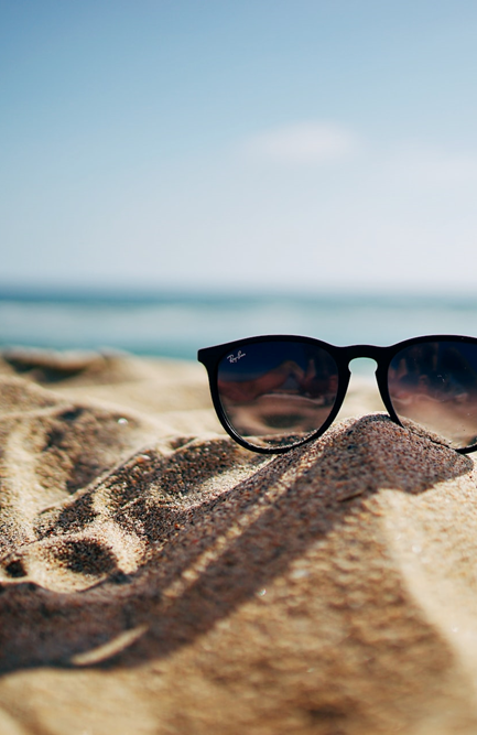 A pair of sunglasses on a sandy beach in Scottburgh, near the Anchored Inn